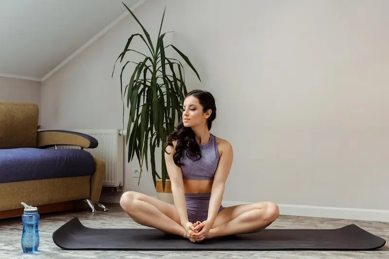 girl-sportswear-practicing-yoga-mat-home-self-isolation